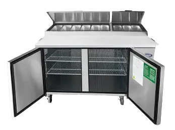 Atosa refrigerated pizza prep table with cutting board and open covers and open doors.