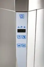 Close up view of corner of dishwasher showing control buttons and digital temperature display